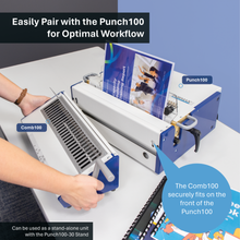 Load image into Gallery viewer, A person is using a blue and white Comb100 binding unit in a studio setting, feeding a printed booklet into a larger Punch100 machine. The scene includes promotional text callouts and a clean white background.