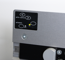 Load image into Gallery viewer, Close-up of a metallic gray electronic control panel with a black display showing pitch-control and automatic on/off indicators, alongside a silver adjustment knob and a small ruler scale. Binding machine