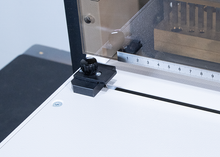 Load image into Gallery viewer, Close-up of a white machine component with a black adjustment knob, a metal ruler, and a transparent protective cover.