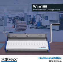 Load image into Gallery viewer, FORMAX Wire100 modular manual closing machine shown in a clean studio-style product shot with a blurred office production background. The machine is white with blue side accents and a beige handle, with the FORMAX logo visible on the front.