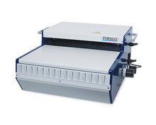 Load image into Gallery viewer, FORMAX booklet binding machine with a white top and front panel, dark blue side frames, and black adjustment knobs, shown on a plain white background.